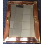 A stylish copper and nickel mounted wall mirror wi