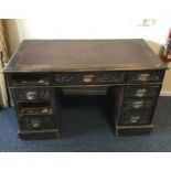 An oak carved twin pedestal desk with leather inse