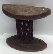 A carved tribal double sided stool. Est. £20 - £30