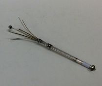 An Edwardian silver swizzle stick with loop top. A