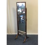 A mahogany dressing mirror on reeded supports. Est