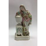 An early Staffordshire figure of a lady in floral