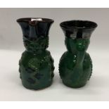 A pair of unusual pottery toby jugs decorated in g