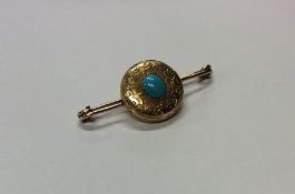 A small engraved brooch inset with turquoise. Appr