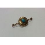 A small engraved brooch inset with turquoise. Appr