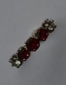 A good 18 carat garnet and diamond five stone ring