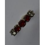 A good 18 carat garnet and diamond five stone ring