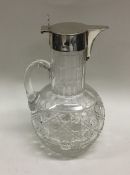 An Edwardian silver hinged top lemonade jug with p