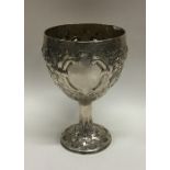 A chased Georgian silver goblet embossed with flow
