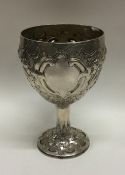A chased Georgian silver goblet embossed with flow