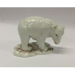 An Antique figure of a polar bear cub with texture