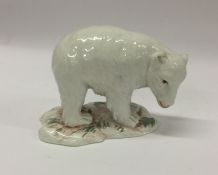 An Antique figure of a polar bear cub with texture