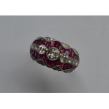 A stylish ruby and diamond cocktail ring with scro