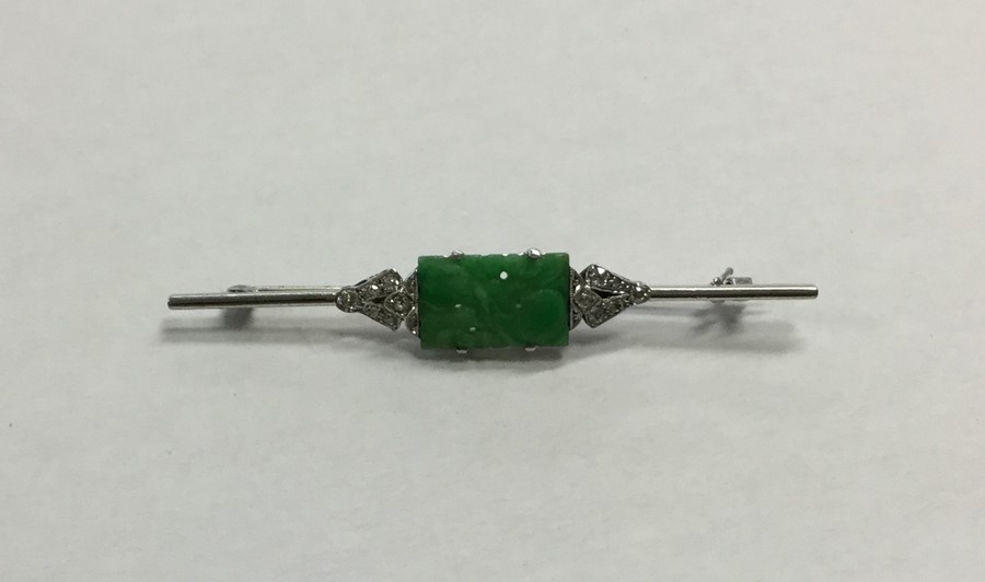 A stylish platinum, jade and diamond brooch of Ori