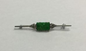 A stylish platinum, jade and diamond brooch of Ori
