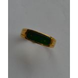 An 18 carat gold green stone ring with rubover mou