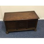 An oak hinged top blanket box on bun feet. Est. £1