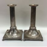 A pair of Continental cast silver candlesticks wit