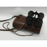 A pair of leather cased Military binoculars. By Ba