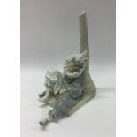 A porcelain figure of a sleeping clown. Est. £20 - £3