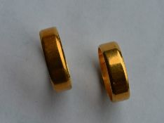A pair of 18 carat gold wedding bands of plain des