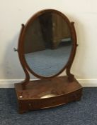 A Georgian mahogany bow fronted toilet mirror. Est