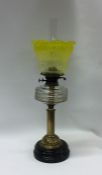 An attractive brass mounted oil lamp with etched y