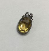 A large oval faceted citrine brooch attractively s