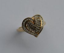 A 9 carat diamond heart shaped cluster ring. Appro