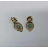 A pair of 18 carat turquoise mounted earrings. App