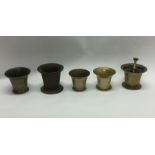 A group of five brass mortars. Est. £30 - £50.