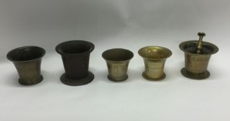 A group of five brass mortars. Est. £30 - £50.