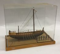 A handmade wooden model of a ship with perspex dom