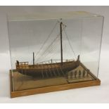 A handmade wooden model of a ship with perspex dom