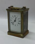 A small oak cased carriage clock with white enamel