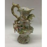 An attractive porcelain ewer decorated with winged