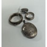A small silver engine turned locket together with