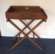 An old butler's tray on stand. Est. £30 - £50.