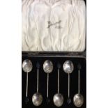 A boxed set of six silver bean top coffee spoons.