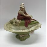 A Royal Dux figure of a stylish lady on lily pad.