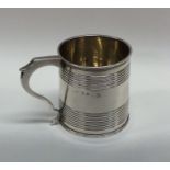 A Georgian silver miniature cup with reeded edges.