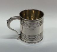 A Georgian silver miniature cup with reeded edges.