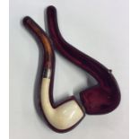 An amber mounted pipe in fitted leather case. Est.