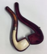 An amber mounted pipe in fitted leather case. Est.