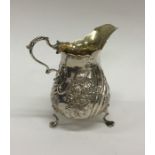 A Victorian silver cream jug with swirl feet. Lond