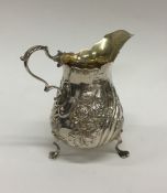 A Victorian silver cream jug with swirl feet. Lond