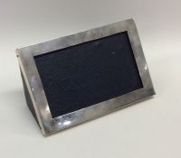 A modern silver desk picture frame with leather ba