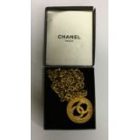 CHANEL: A massive gold plated pendant on chain. Es