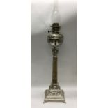 A massive silver plated and onyx oil lamp decorate