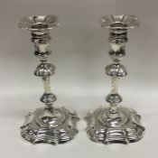 A good pair of George II cast silver candlesticks